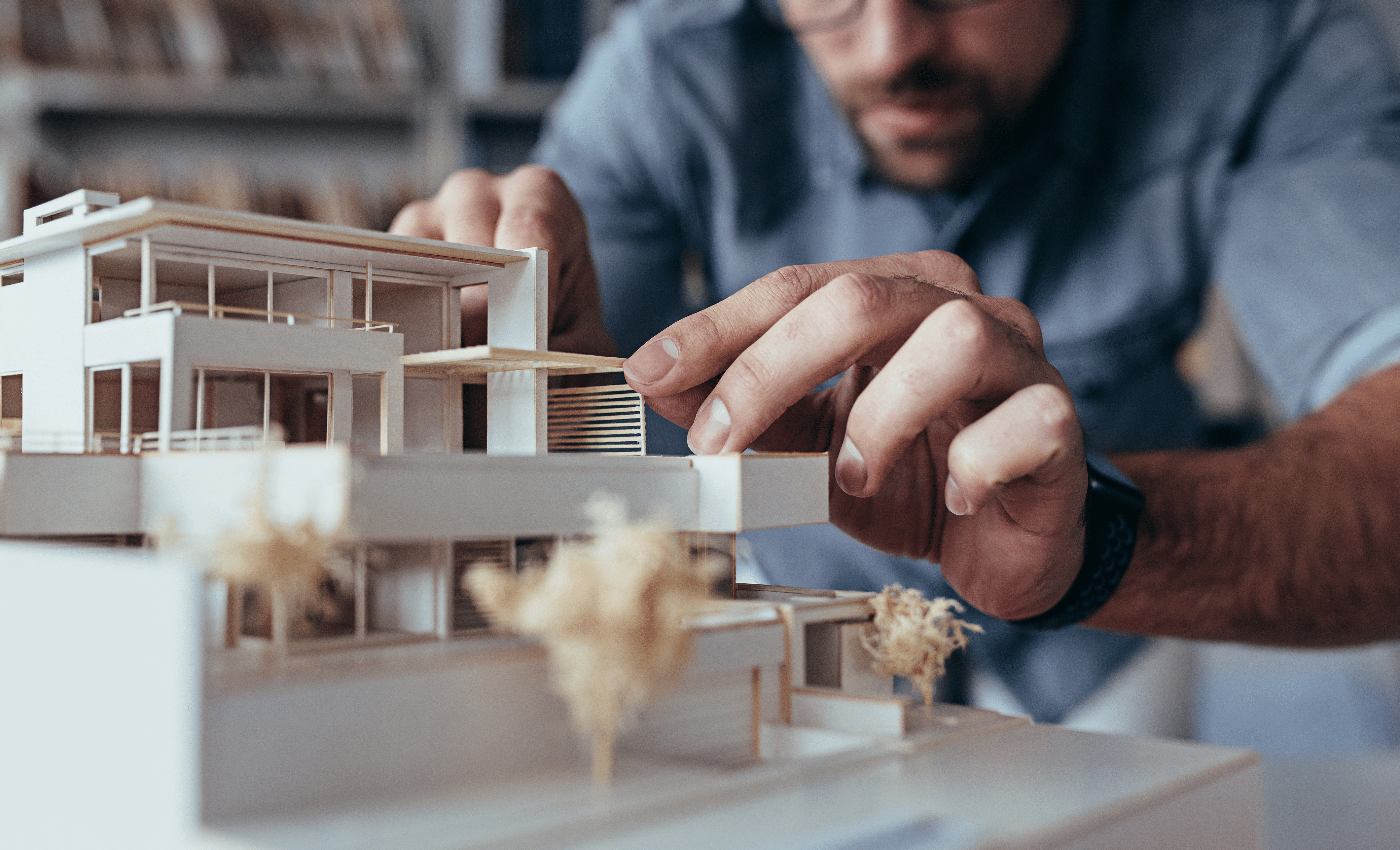 architect working on a building model and asking himself why is lighting essential to architecture